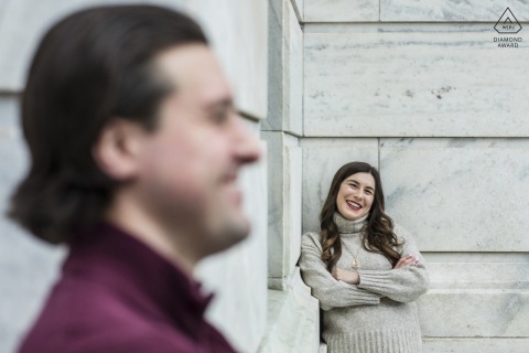 Inside the marble atrium of the Cleveland Museum of Art, the engaged couple poses with elegance, their loving expressions and stylish attire complemented by the light-filled sophistication of the museum’s impressive interior.