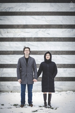 A playful, snowy scene unfolds outside the Cleveland Museum of Art in Cleveland, Ohio, where the couple poses amid freshly fallen snow, their hand holding adding warmth to the winter day.