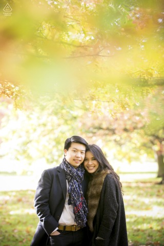 In London, UK, the couple poses for a portrait, their warmth and connection brought to life by the energy of the green park setting that surrounds them.