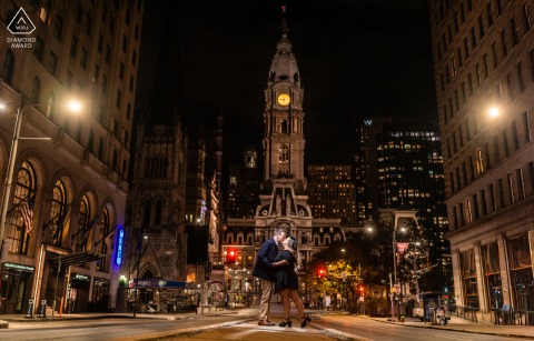 Under the illuminated clock of Philadelphia City Hall, two hearts meet for an engagement portrait, the historic building serving as the perfect backdrop to their quiet connection.