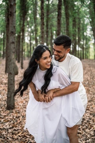 Among the eucalyptus trees at Mar de Eucaliptos in Alagoas, Brazil, a couple laughs together in a lighthearted session.