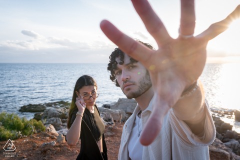 A couple poses along the picturesque shore of Bandol, Var, in Provence, France, highlighting the natural beauty of the Mediterranean coast during their romantic outdoor engagement portrait session.