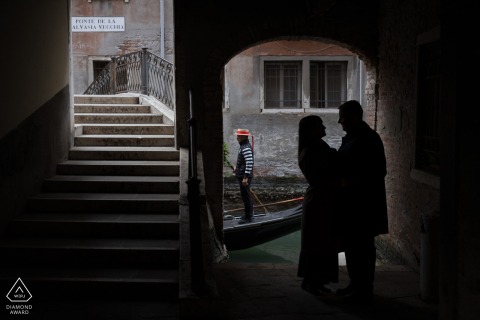 In Venice The Couple Poses In A Romantic Engagement Session Along Historic Waterways In Venice, the couple shares a romantic engagement photoshoot surrounded by historic waterways, soft light, and classic Italian scenery that enhances their connection.