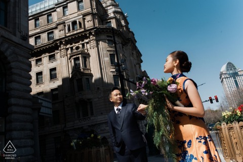 On The Bund In Shanghai He Leads Her Hand Through Sunlit Historic Streets For Engagement Session On the Bund in Shanghai, China, he leads her by the hand through sunlit streets, while historic buildings frame an elegant, timeless portrait full of romance.