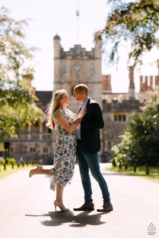 Quiet Romance Fills The Driveway At Rhinefield House In Hampshire, England Before The Wedding An engaged couple shares a quiet moment in the driveway of Rhinefield House in Hampshire, England, ahead of their upcoming wedding.