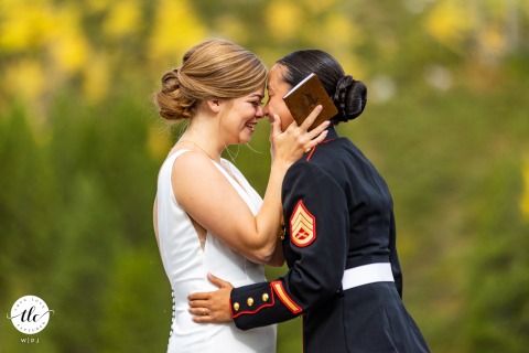 In Grand Teton National Park, Wyoming, USA the couple gently press their foreheads together, sharing a tearful and intimate moment while reading their vows.