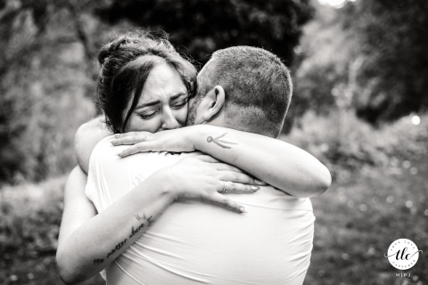 Bride Tightens Emotional Hug With Her Brother Outdoors At Domaine De L’Ecoutoux In Quaix-en-Chartreuse, France Tucked outdoors at Domaine de l’Ecoutoux in Quaix-en-Chartreuse, France, the bride tightly hugs her brother, eyes closed in emotion, savoring a touching sibling moment.