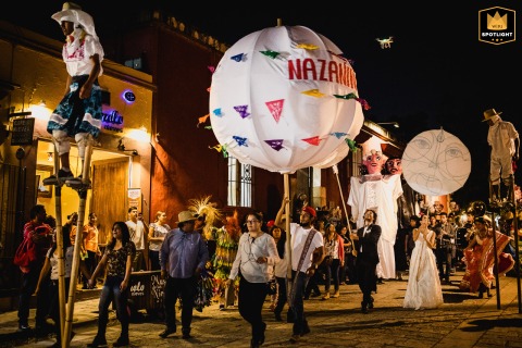 In Oaxaca, Mexico, a traditional wedding calenda procession takes place on the streets at night, celebrating with music and dance.