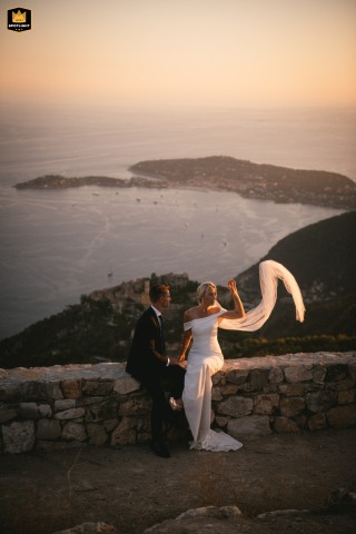 Nice, France: The bride playfully manipulates her veil with the open sea as a backdrop.