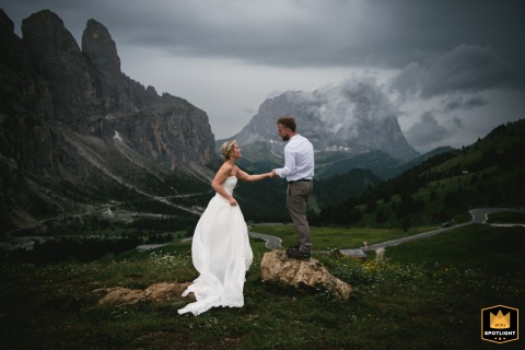 Dolomites, Italy: The couple traverses rocky terrain in the mountains.