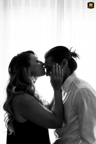 Cesena, Italy: The groom and his sister share a heartfelt embrace at a private house, as she kisses his forehead.