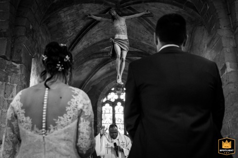 In Précy-sous-thil, a black and white shot from behind captures the priest blessing the couple.