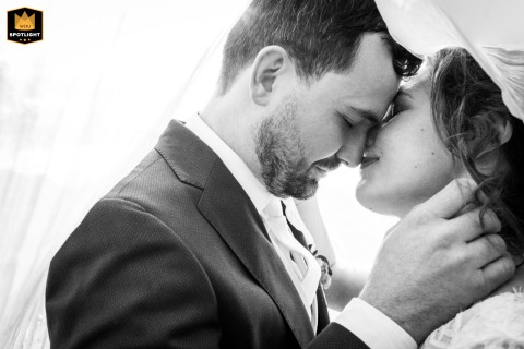 At Château de Millery-Autun, an intimate, tight black and white shot captures the couple beneath the veil.