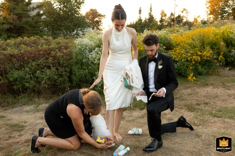 At Newagen Seaside Inn, Maine, the wedding planner and groom tend to the bride's feet, bandaging them so she can wear her heels for the reception.