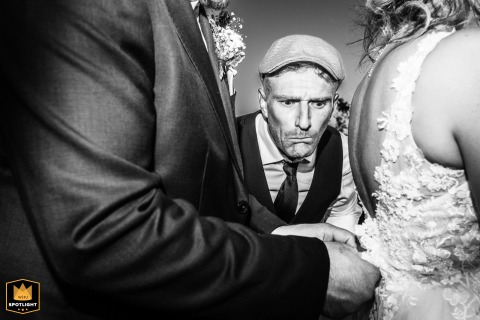 At Domaine Laffont, a witness looks intrigued as the groom tries to reattach the bride's dress train.
