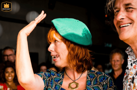 A WPJA wedding photo: After the ring, the bride in Gelderland, Netherlands playfully displays her ring to guests, tongue slightly out.