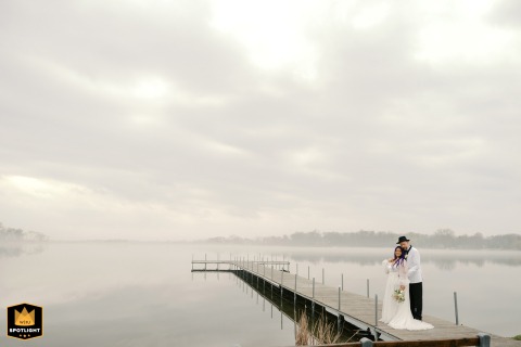 After a brief storm, enchanting fog blankets the lake at Bass Bay Brewhouse, Muskego, WI, creating a magical wedding scene.
