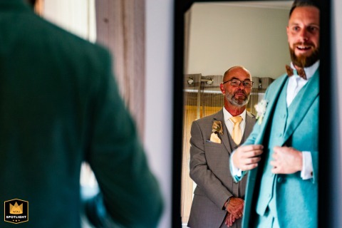 In Nouvelle-Aquitaine, the groom dresses in front of his father during his preparations, captured by a WPJA photographer.