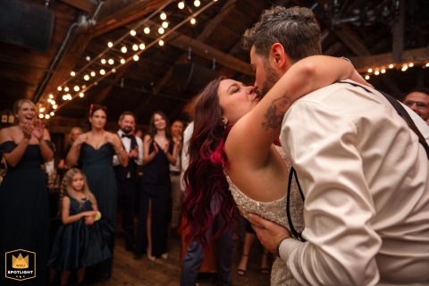 Bride and groom share a romantic first dance at Auberge Saint-Gabriel, Old Montreal, surrounded by warm light and smiling guests.