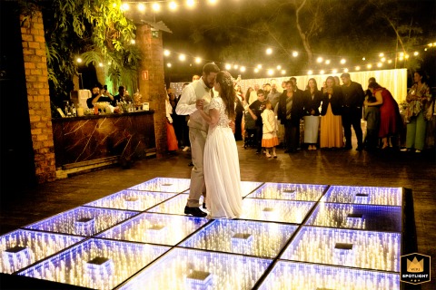 Bride and groom share a beautiful first dance at Enjoy Eventos in Porto Alegre, captivating guests with their elegance and love.