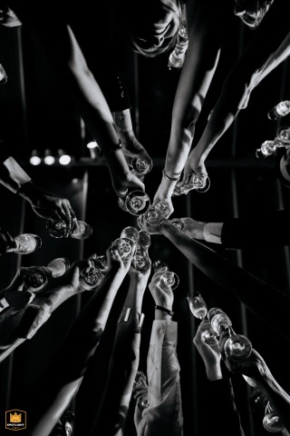 In São Paulo, a low-angle, black and white detail shot captures a massive champagne toast, celebrating the special day.