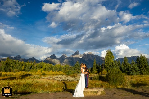 In Grand Teton National Park, Wyoming, a couple uses a bench to even their height difference, captured by a WPJA photographer.