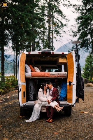 At Lake Cushman, WA, a bride and groom snuggle in their camper van, their home on wheels for many adventures.