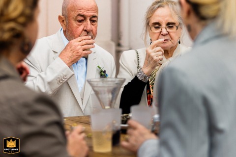At a wine tasting during the reception in Pays Basque, guests are absorbed in the flavors, a candid scene of shared pleasure.