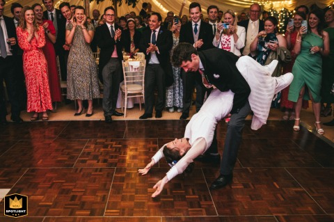 Bride and groom share their romantic first dance at their wedding reception in Stratford Upon Avon, surrounded by joyful guests.