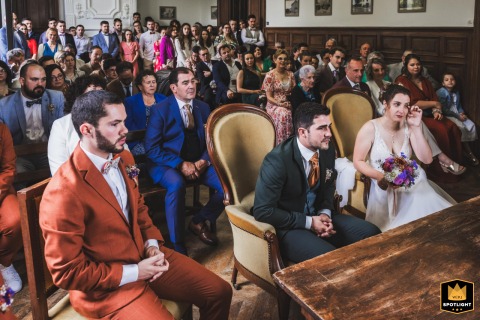 The bride and emotional guests, some wiping tears, react during the mayor’s speech at a wedding in Saint-Cricq-Chalosse, France.