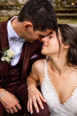 Bride and groom share a romantic pose for a wedding portrait at Chateau d’Escart, Avrillard, Savoie, France, smiling lovingly.