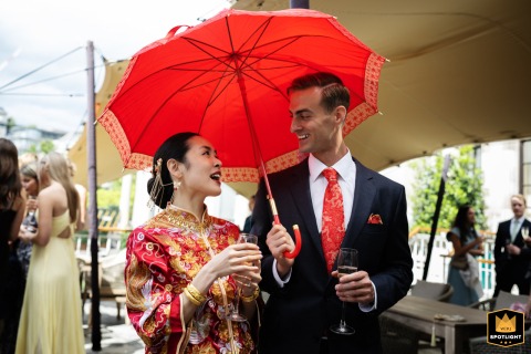 At No.4 Hamilton Place, a couple at their Chinese wedding, with the groom holding a red parasol over the bride.