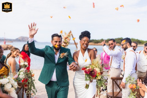 Confetti showers a couple exiting their outdoor ceremony in Olbia, Sardegna, Italy, captured by a WPJA photographer.