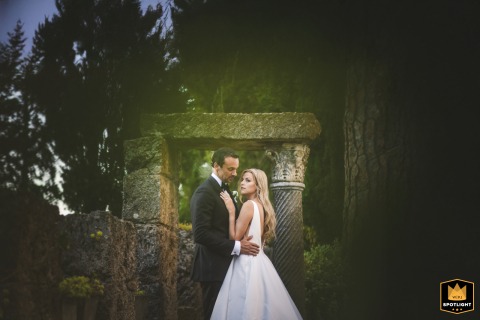 At Rocca di Cetona in Tuscany, the couple is captured in an artistic portrait, thoughtfully framed by ancient stone architecture and lush surroundings, creating a romantic and timeless image.