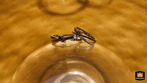 At home in Shanghai, China, a detail shot captures the wedding rings resting delicately on a lamp, their simple beauty illuminated in soft, intimate light.