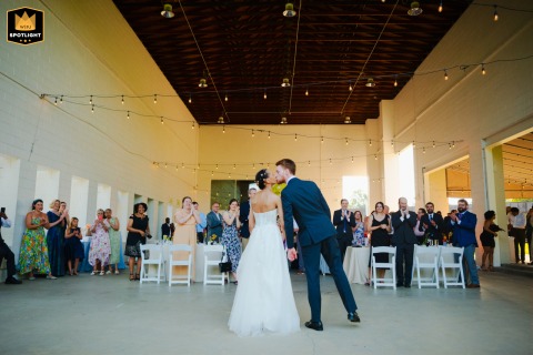 At The Gem in Pittsburgh, PA, the newlyweds share a tender kiss after performing their first dance, capturing the joy and pure romance of their wedding celebration.