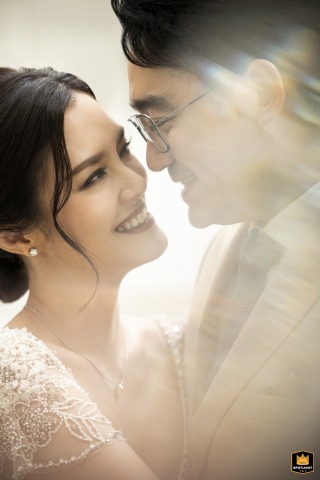 At Mandarin Oriental Bangkok, the couple poses face to face for a vertical, artistic portrait. Their intimate connection is beautifully highlighted by creative composition and soft lighting.