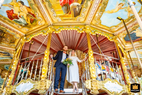 At the merry-go-round on Place Wilson in Toulouse, the couple shares a joyful session together before heading to city hall. Their happiness and anticipation shine in this playful, romantic pre-wedding portrait amid the vibrant city backdrop.
