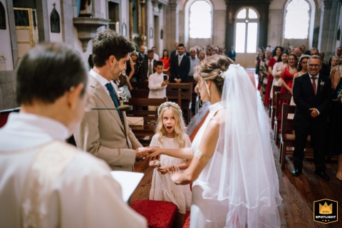 At a church in S.J. Madeira, Portugal, the ring bearer is surprised by her bride-mum. She entered early to deliver the rings, creating a sweet, unexpected moment.