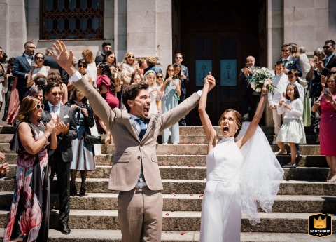 At a church in S.J. Madeira, Portugal, the newlyweds celebrate, clearly thrilled to finally be married. Their joyous expressions convey deep happiness.