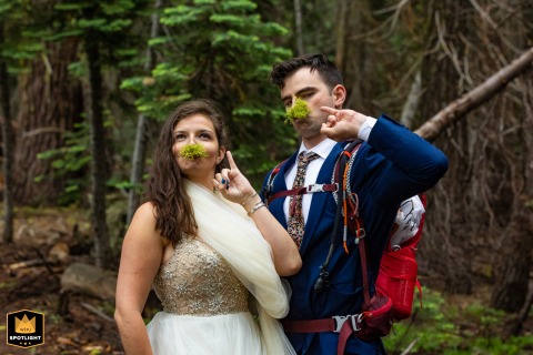 In Yosemite National Park, California, a couple playfully puts moss mustaches on their faces during a hike.