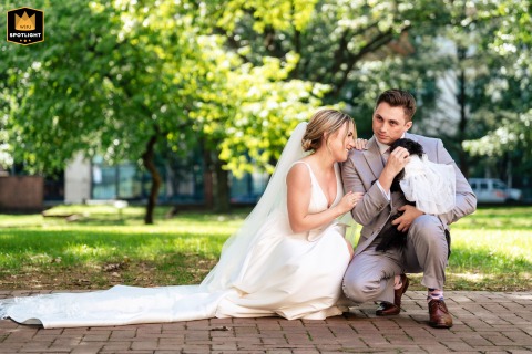 A couple is captured in a Philadelphia park like setting with their fur baby. This sweet portrait showcases their beloved pet before they head to the wedding ceremony.