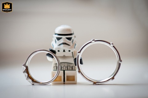 At a movie-themed wedding in Sussex, a Star Wars Stormtrooper Lego figurine holds up the wedding rings. The playful detail adds a unique touch to the ceremony.