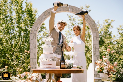 At Quinta Largo da Vila in Portugal, champagne is poured into a tower of glasses. The festive moment captures the joyous mess of a wedding celebration.