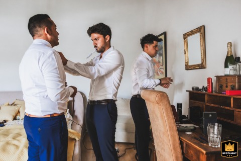 At Domaine La Chartreuse in Dordogne, France, a groom prepares for his wedding with his groomsmen. They share a moment of anticipation just before the ceremony begins.