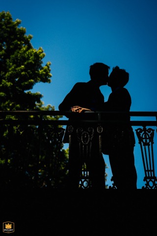 In the Catskills, New York, the couple share a kiss on a picturesque bridge. Sunlight beautifully illuminates their newly exchanged wedding bands, highlighting their joyful union and the beginning of their new life together.
