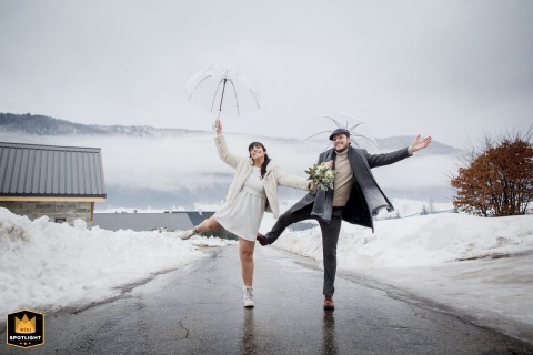In Meaudre, France, a bride and groom pose playfully during a fun winter wedding portrait session. The happy couple's lightheartedness is captured in this joyous image.