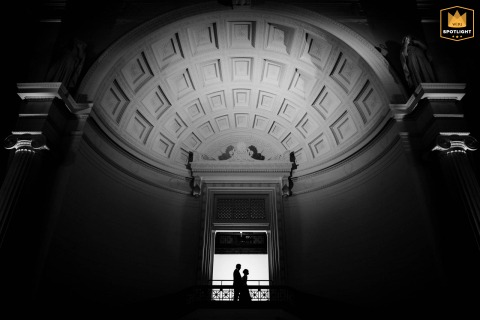 Inside Chicago’s Field Museum, a striking black and white silhouette captures a wedding couple in a dramatic, graphic scene. The creative composition uses museum architecture and lighting to highlight their connection.