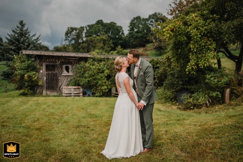 In Siegerland, Germany, the newlyweds are captured in a series of wedding portraits. The couple shares a tender kiss, showcasing their affection and joy in a classic photograph.