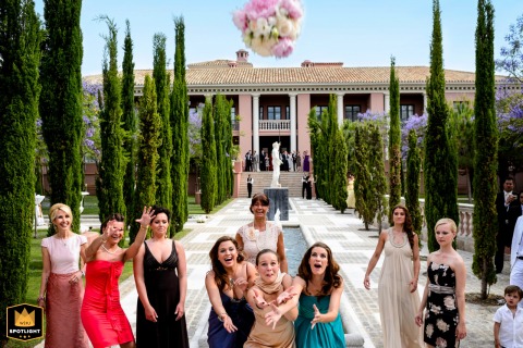 Catching Joy in Marbella: A Wedding Bouquet Toss at Villa Padierna Marbella, Spain: Women joyfully catching a tossed bouquet at a wedding at Villa Padierna.